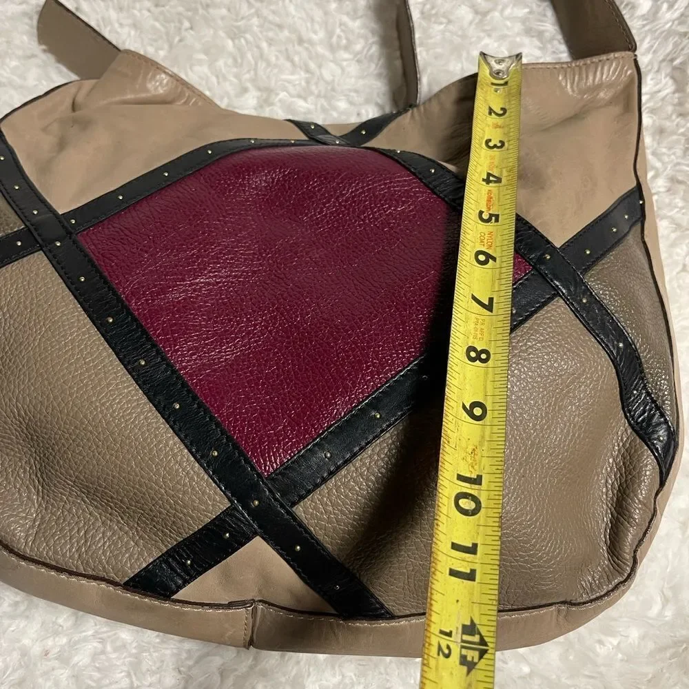 A. Bellucci leather Khaki Satchel with patch work accents, gay, burgundy &black.